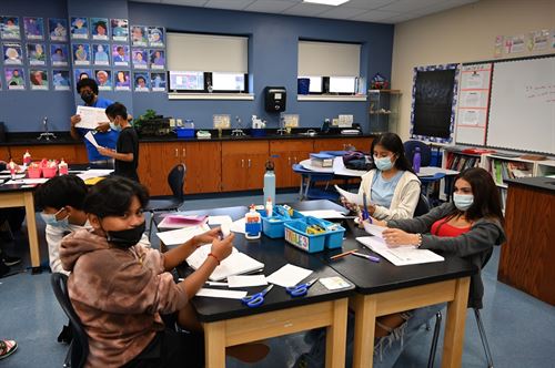 students at table with art